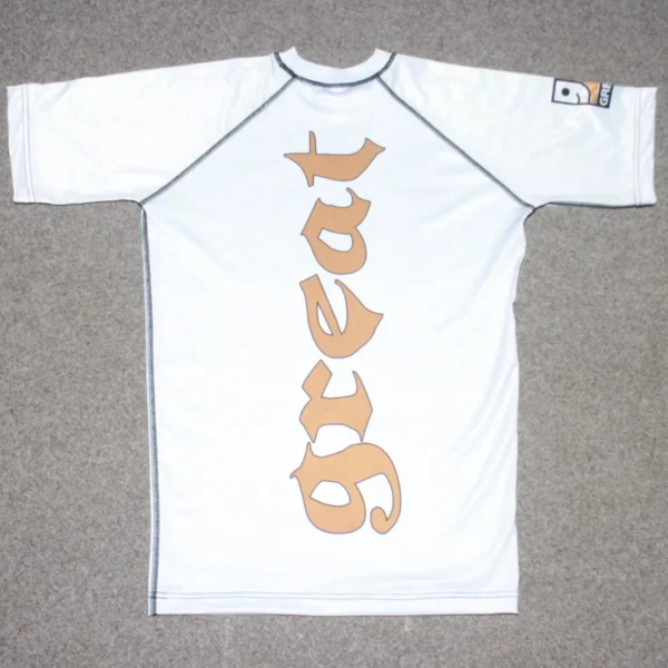 a white rashguard shirt with brown great logo on it